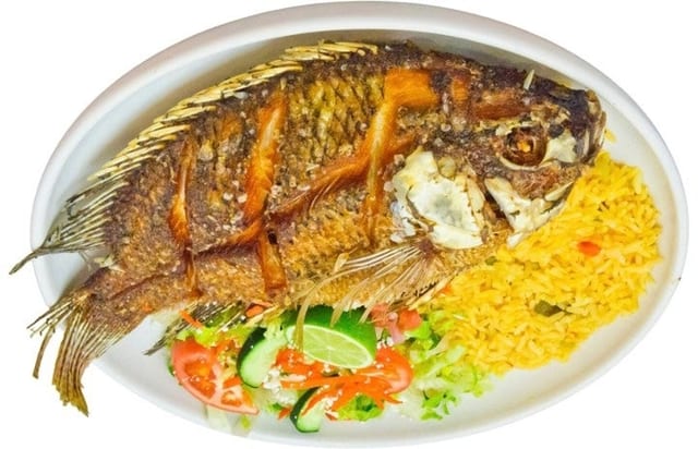 Mojarra Frita (Fried Tilapia Fish) con Tostones (Salted Plantain Crisps).