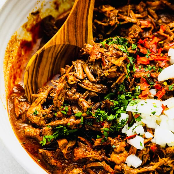 Close-up of Cielito Lindo's shredded Mexican barbacoa with cilantro, diced onions, and red chili flakes.